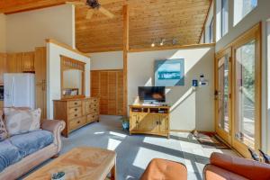 a living room with a couch and a tv at Mtn-View Deck: Cabin Getaway in Angel Fire in Angel Fire