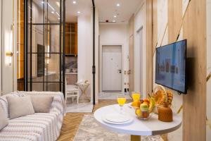 a living room with a couch and a table at Nest One Luxe, Элитные апартаменты с террасой и панорамным видом in Tashkent