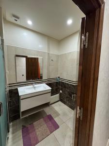 a bathroom with a sink and a mirror at 3 bedroom apartment with living room and terrace 90metre in El Harhoura