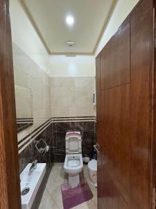 a small bathroom with a toilet and a sink at 3 bedroom apartment with living room and terrace 90metre in El Harhoura +13 photos