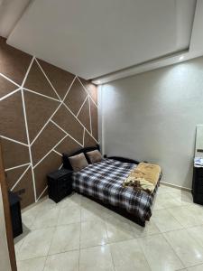 a bedroom with a bed in the corner of a room at 3 bedroom apartment with living room and terrace 90metre in El Harhoura