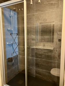 a shower with a glass door in a bathroom at El Marquesado de Santiago en Milladoiro in Amés