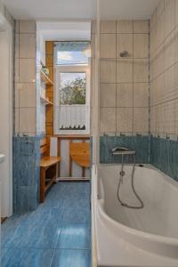 a bathroom with a tub and a sink at Interbelic Villa near Old Town in Bucharest +61 photos