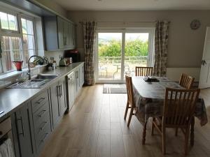 a kitchen with a table and chairs and a dining room at Bungalow in Baltinglass in Baltinglass