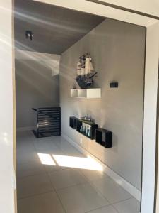 a room with a white wall with a shelf on it at Hotel Flor D Liz in Goiânia