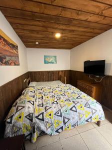 a bedroom with a bed with a quilt on it at Hostal Boutique Reina del Mar in Cartagena +33 photos