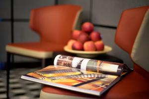 a tray with a plate of fruit on a table at Hotel 81 Premier Hollywood in Singapore