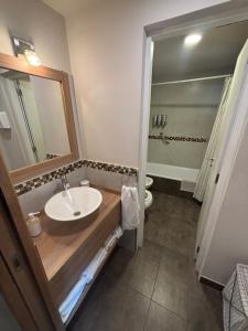 a bathroom with a sink and a toilet at Andalue in San Carlos de Bariloche