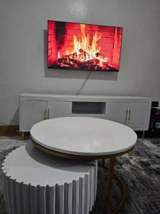 a table in a room with a fire in the wall at Glome Stays in Kisumu