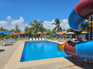 a pool at a resort with a water slide at Hotel Praia do Conde in Conde