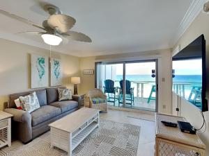 a living room with a couch and a view of the ocean at Regency Towers #505 West in Oriole Beach