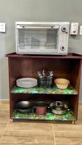 a microwave oven sitting on top of a shelf at Alojamiento Paraiso del Parana in Carmen del Paraná