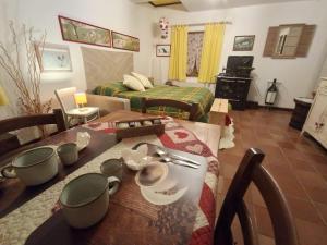a living room with a dining table and a bedroom at Pass Assaggiando in Rubiana