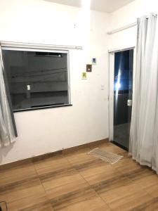 a living room with a window and a door at Sua Casa em MSP in Morro de São Paulo
