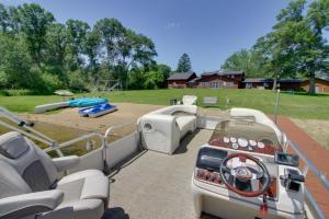 a pontoon boat parked in a yard with a playground at Lakefront Home on 17 Acres 9 Mi to Dtwn Brainerd! in East Gull Lake