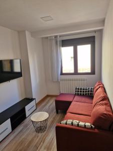 a living room with a couch and a flat screen tv at El peromato in Zamora