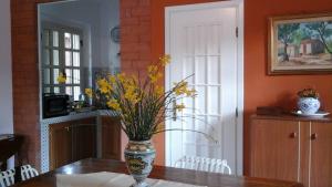a vase with yellow flowers sitting on a table at Il Giardino sul Mare in Acquedolci