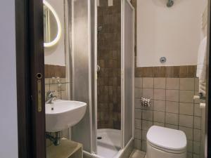 a bathroom with a toilet and a sink at Domus Oleandri - WelcomeToRhome in Rome +29 photos