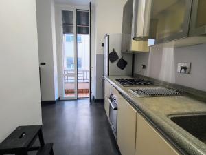 a kitchen with a stove top oven next to a sink at Domus Oleandri - WelcomeToRhome in Rome