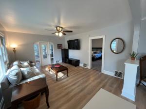 a living room with a couch and a table at Beach town bungalow in Sheboygan