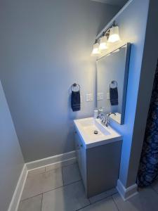 a bathroom with a sink and a mirror at Beach town bungalow in Sheboygan