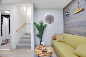 a living room with a yellow couch and a table at Apartment Minutes from Camelback Mountain with Washer Dryer in Tannersville
