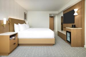a hotel room with a bed and a flat screen tv at Hyatt Regency Times Square in New York +40 photos