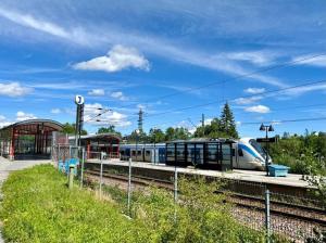 a train on the tracks at a train station at Apartment in Skogås in Skogås