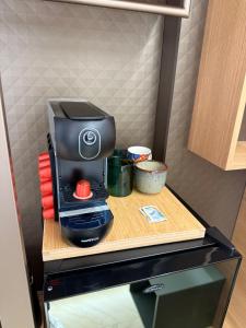 a coffee maker on a table in a refrigerator at Ulivo Guest House Roma in Rome