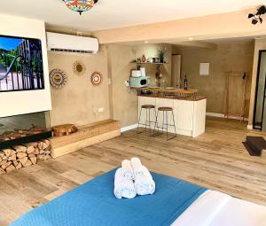 a living room with two pairs of shoes on a blue rug at Boutique apartment in heart of Haifa in Haifa