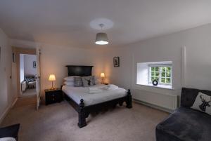 a bedroom with a bed and a couch and a window at Ames Cottage in Hinton