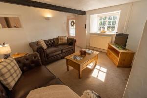a living room with two couches and a coffee table at Ames Cottage in Hinton