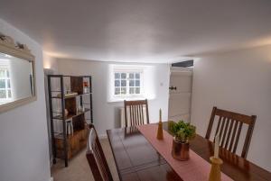 a dining room with a table and chairs and a window at Ames Cottage in Hinton +10 photos