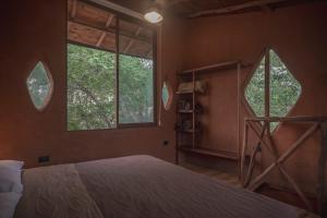 a bedroom with two windows and a bed in it at Casa Iteri in Lo de Marcos