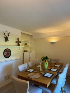 a dining room with a wooden table and chairs at Red House in Hinton