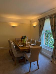 a dining room with a wooden table and chairs at Red House in Hinton