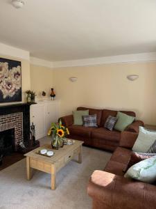 a living room with a couch and a coffee table at Red House in Hinton