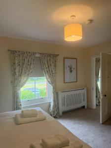 a bedroom with a bed and a large window at Red House in Hinton