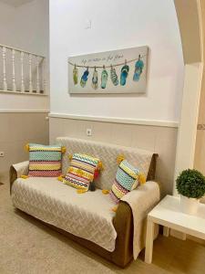 a couch with pillows on it in a living room at Typical Nazaré House in Nazaré