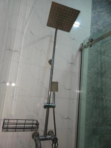 a shower with a light in a bathroom at Eko Luxury Apartments in Ikeja +13 photos
