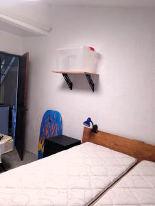 a bedroom with a bed and a shelf on the wall at Relax by the sea in Piriápolis
