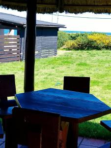 a blue table and chairs in a yard at Relax by the sea in Piriápolis