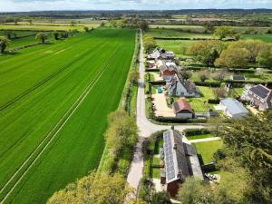 an aerial view of a farm with a field at Foxglove Cottage in Bransgore