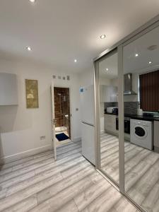 a kitchen with a sliding glass door in a kitchen at Stylish Studio Apartment in Leicester