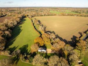 an aerial view of a house in the middle of a field at Hobbs Cottage in Hinton