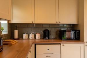 a kitchen with a counter top with a microwave at Rose cottage in Bransgore