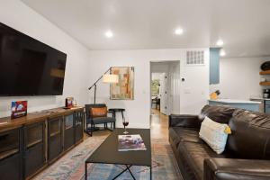 a living room with a couch and a flat screen tv at Near Downtown Stylish 2BR With Amazing Patio - 5 in Moab