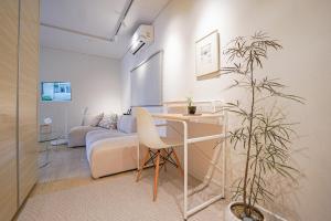 a living room with a table and a couch at Villa de EL 1 in Busan