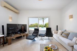 a living room with a couch and a tv at VESTA - El Gouna Residence in Hurghada