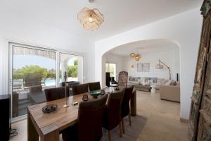 a dining room and living room with a table and chairs at VESTA - El Gouna Residence in Hurghada